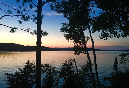 Sunset peeking through trees on Walloon Lake, MI