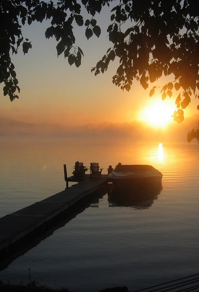 Private dock framed by trees during sunset on Walloon Lake